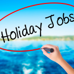 hand writing "holiday jobs" over a water background