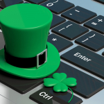 green hat and shamrock on a laptop keyboard