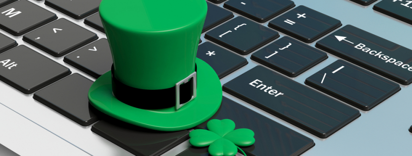 green hat and shamrock on a laptop keyboard