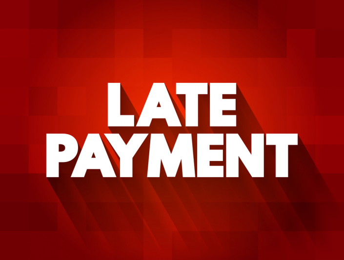 white block letters on red background stating "late payment"