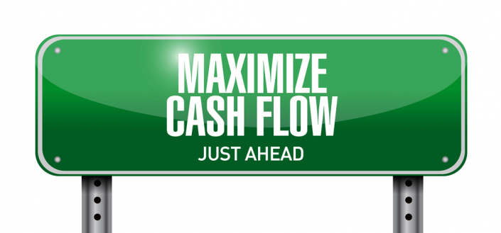 green sign that says "maximize cash flow just ahead"